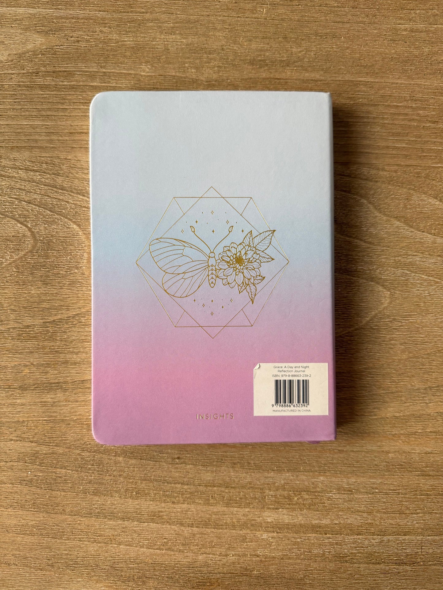 Notebook with a geometric design on a wooden surface