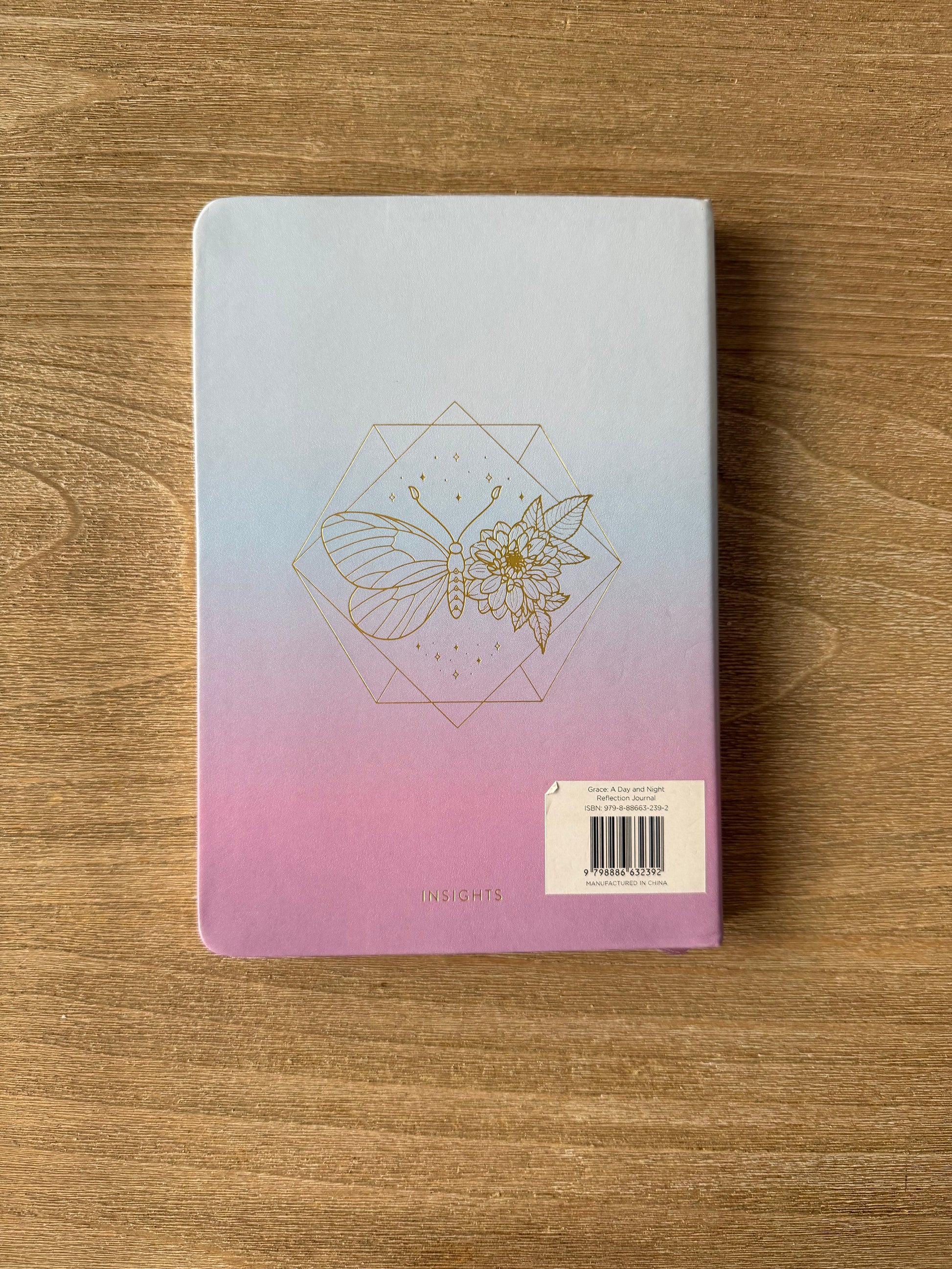 Notebook with a geometric design on a wooden surface