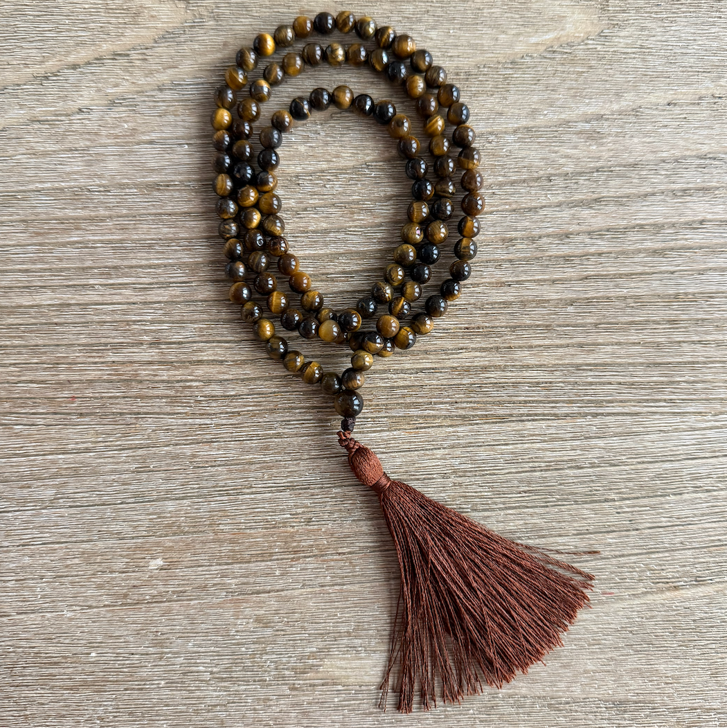Beaded necklace with a tassel on a wooden surface
